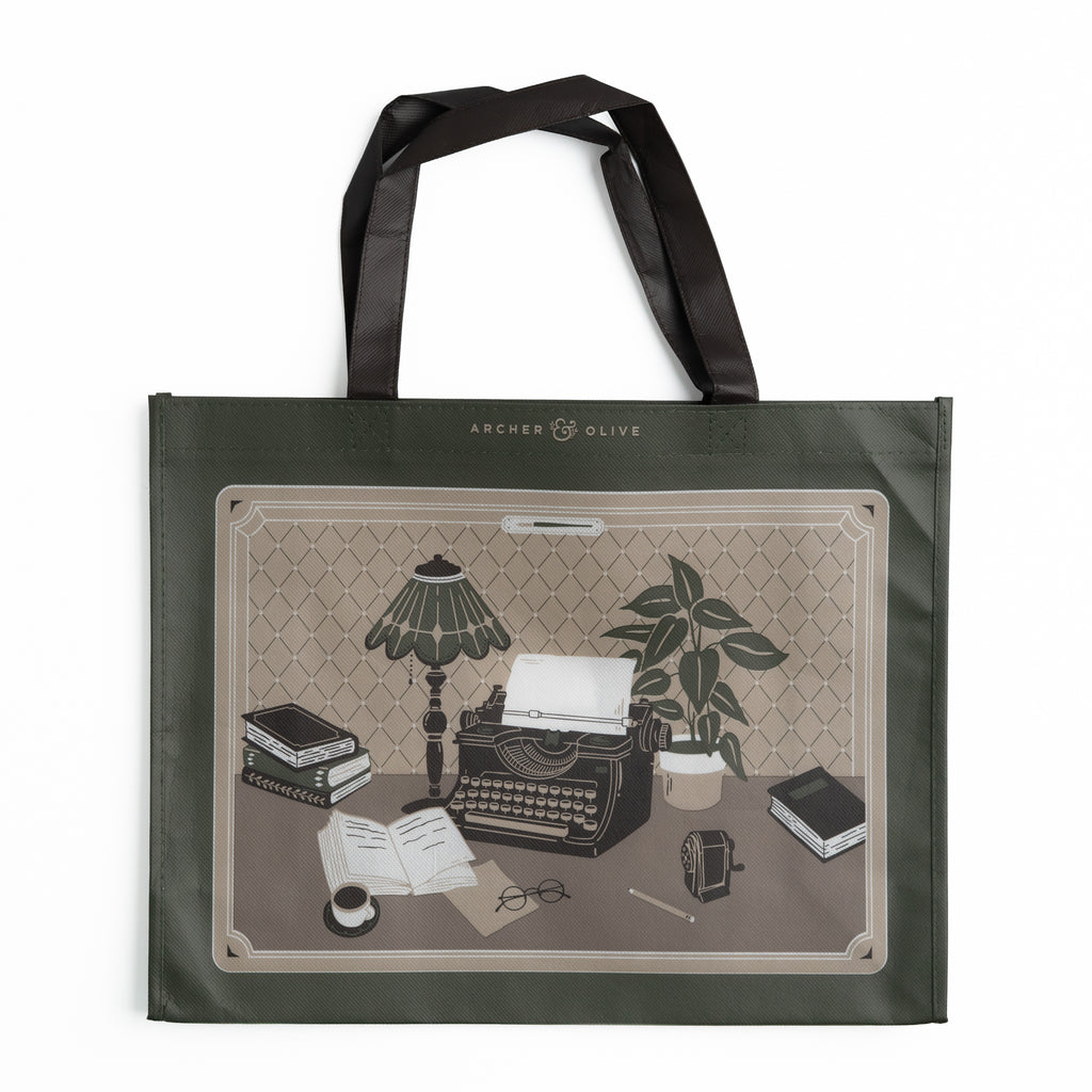 Olive green tote bag illustrated with vintage typewriter and writer's desk scene