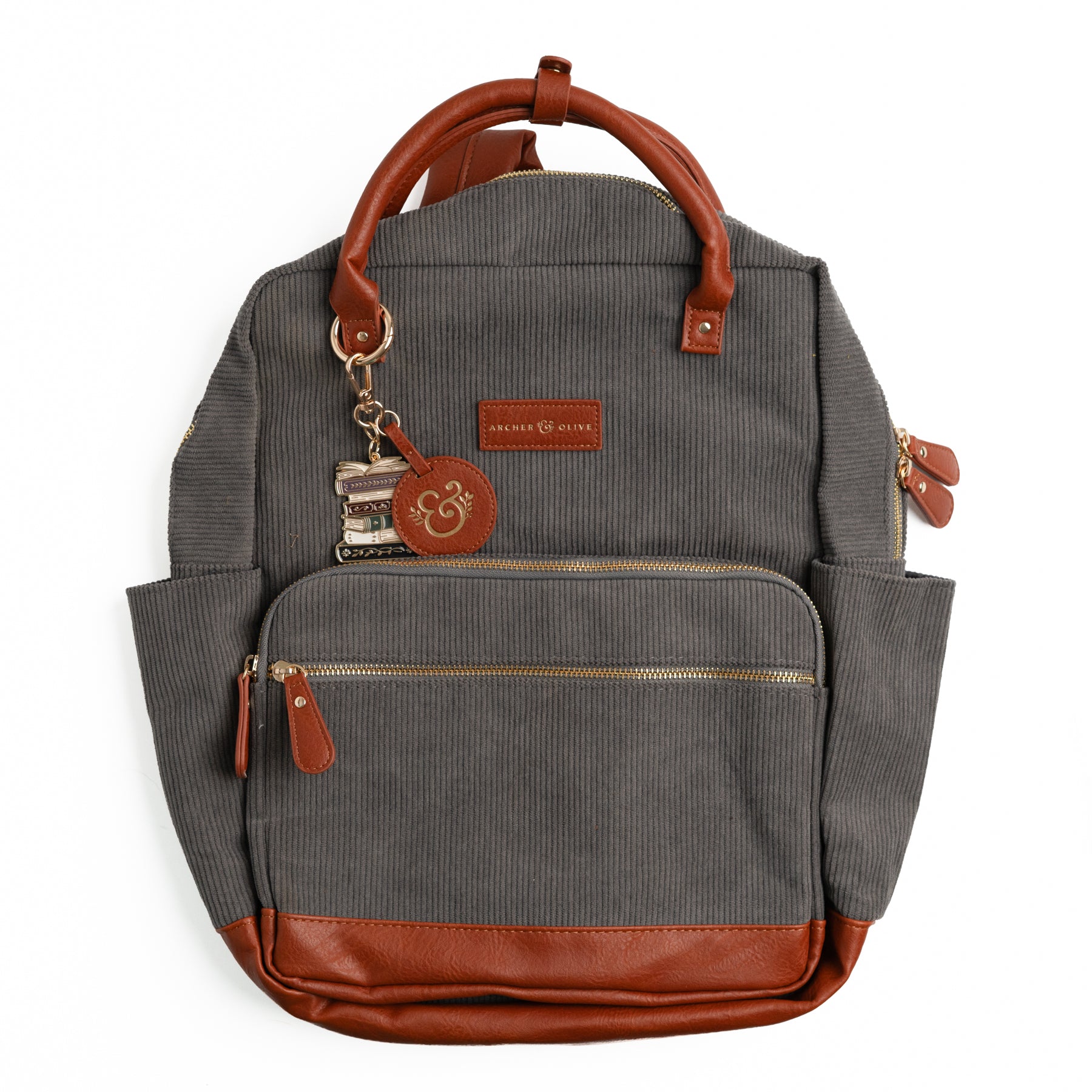 Charcoal gray ribbed corduroy backpack with brown vegan leather trim and book-stack keychain
