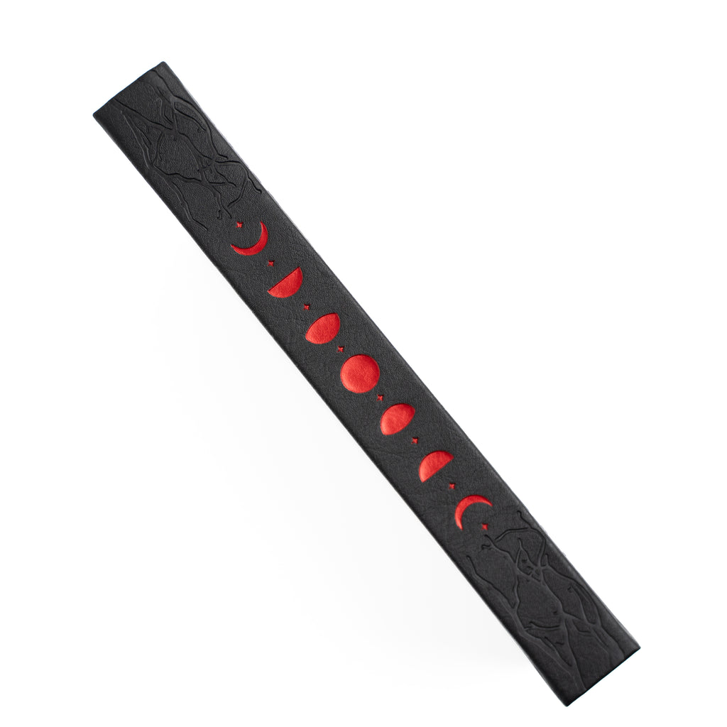 Black Notebook spine with red moon phases on a white background