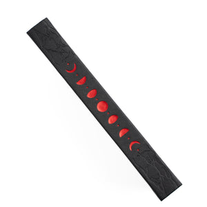 Black Notebook spine with red moon phases on a white background