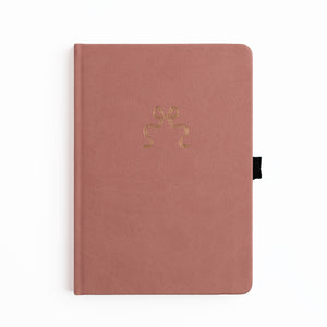 Pink notebook with a gold emblem on a white background