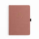 Pink notebook with a gold emblem on a white background