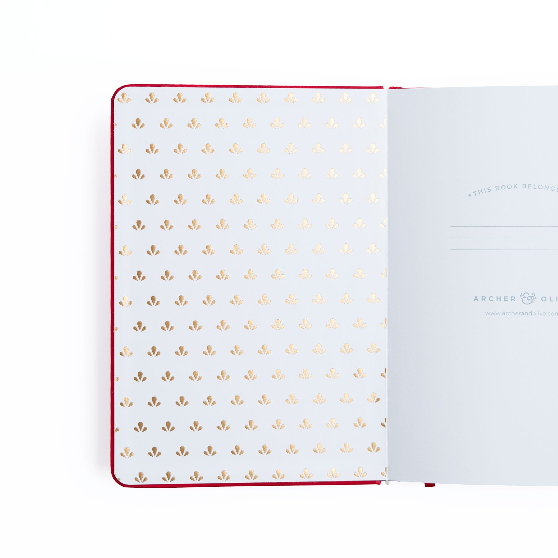 Open notebook with gold dot pattern on white pages, brand 'Archer & Olive' visible.