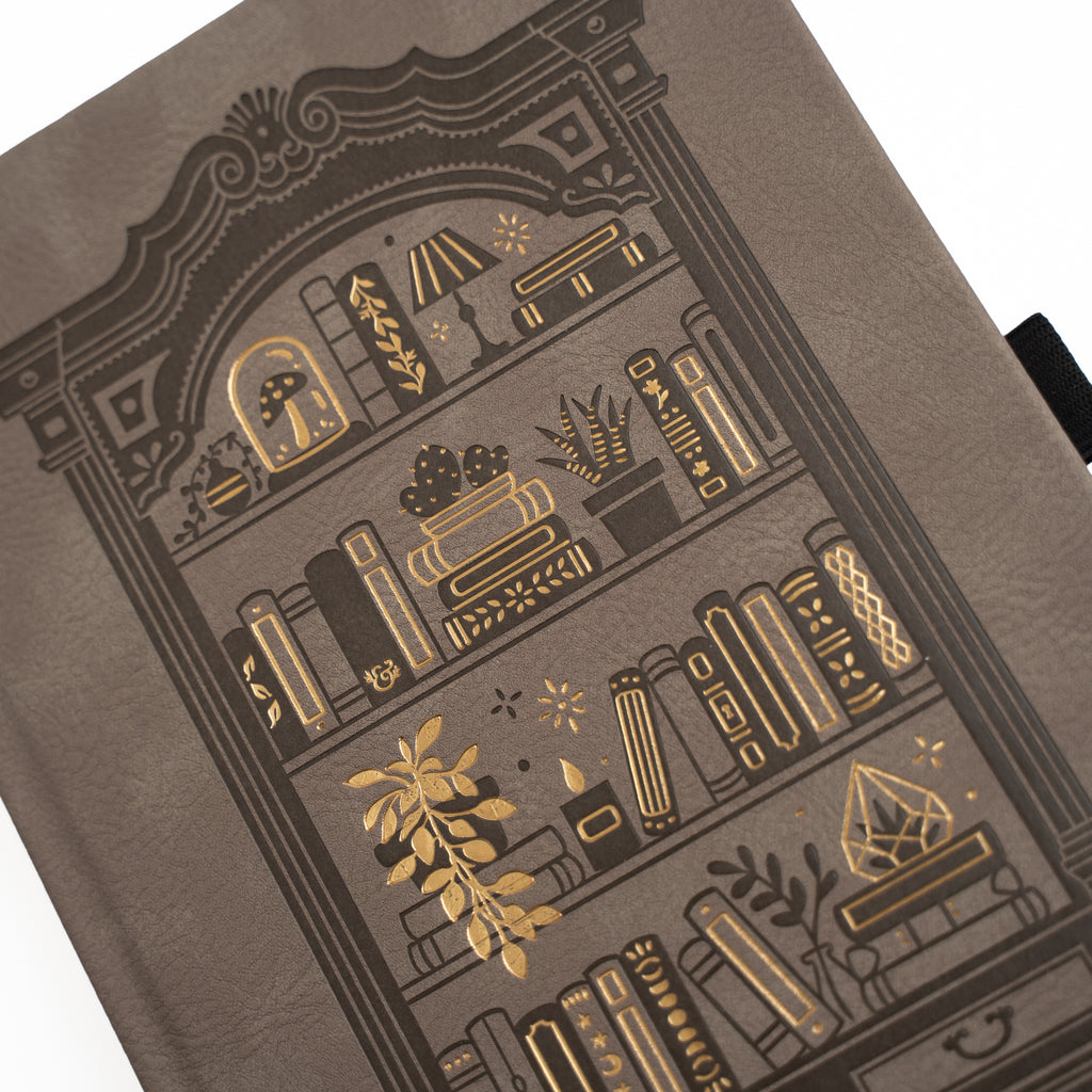 Decorative notebook with gold embossed designs on a brown background