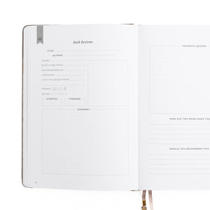 Open notebook with a page dedicated to book reviews on a white background