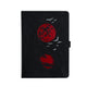 Black notebook with red moon and bird design on a white background